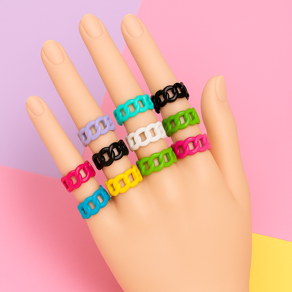 Hand wearing colorful chain-link rings on a pink and purple gradient background