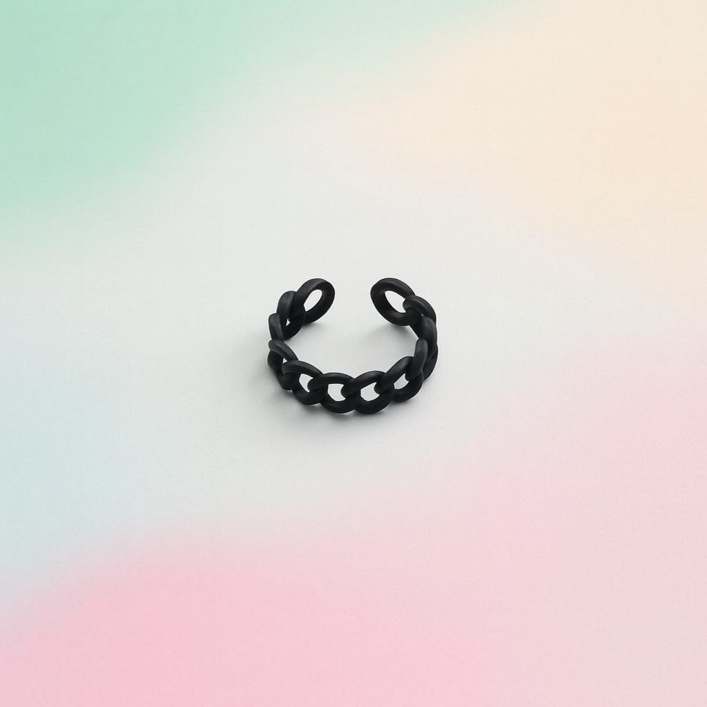 Black chain-style ring on a gradient background