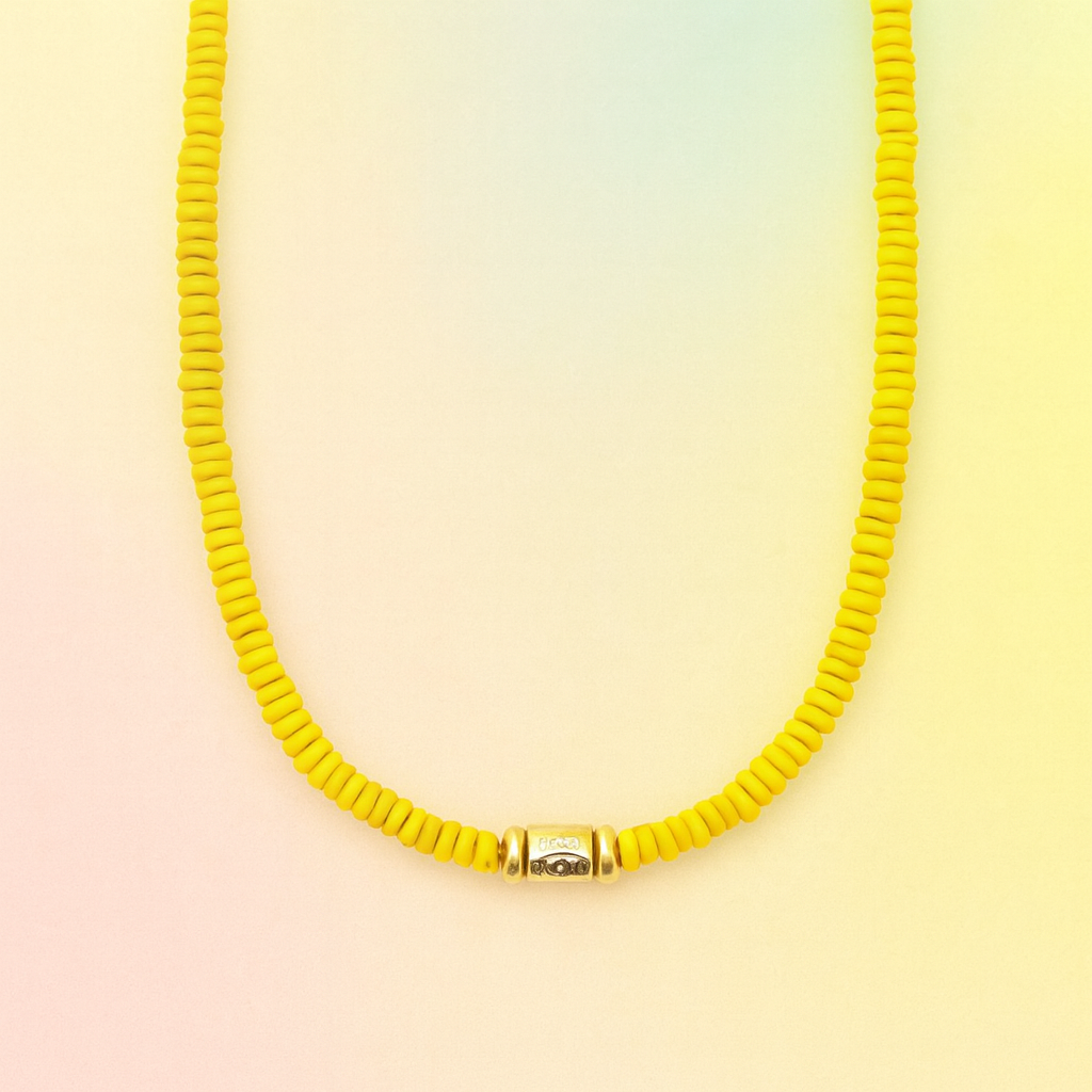 Yellow beaded necklace on a gradient background