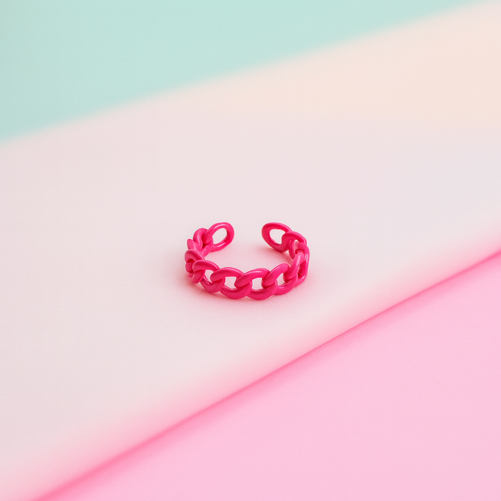 Pink chain-link ring on a gradient pink and blue background
