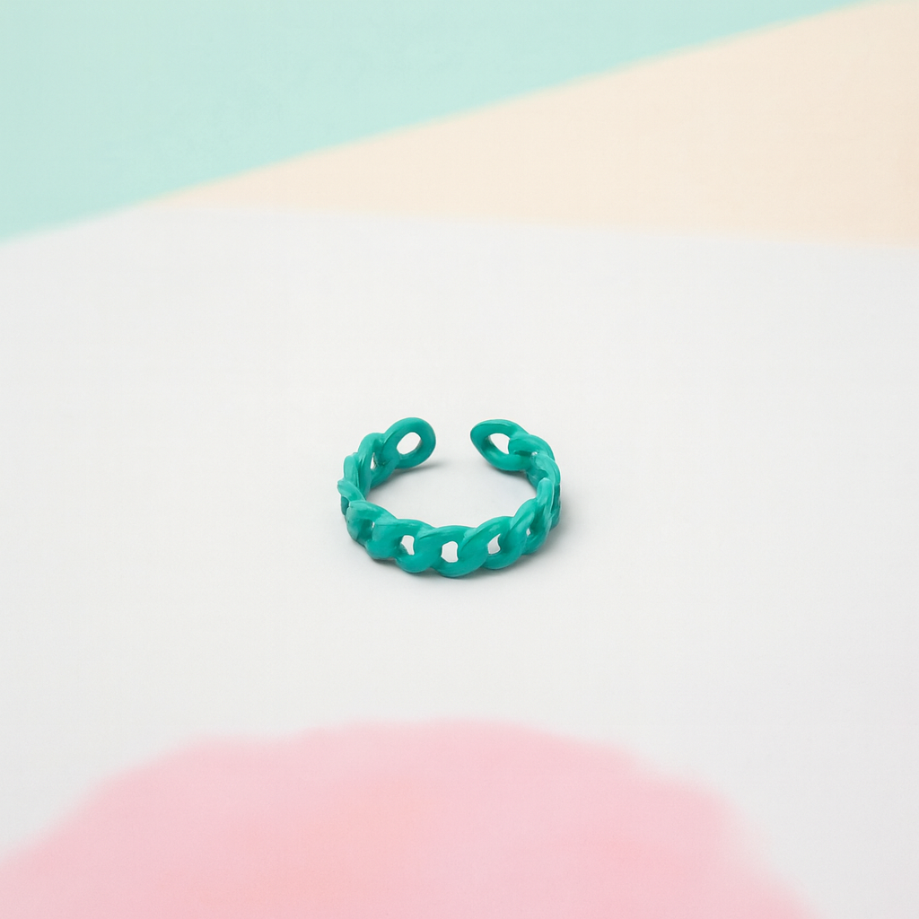 Turquoise chain-link ring on a pastel gradient background