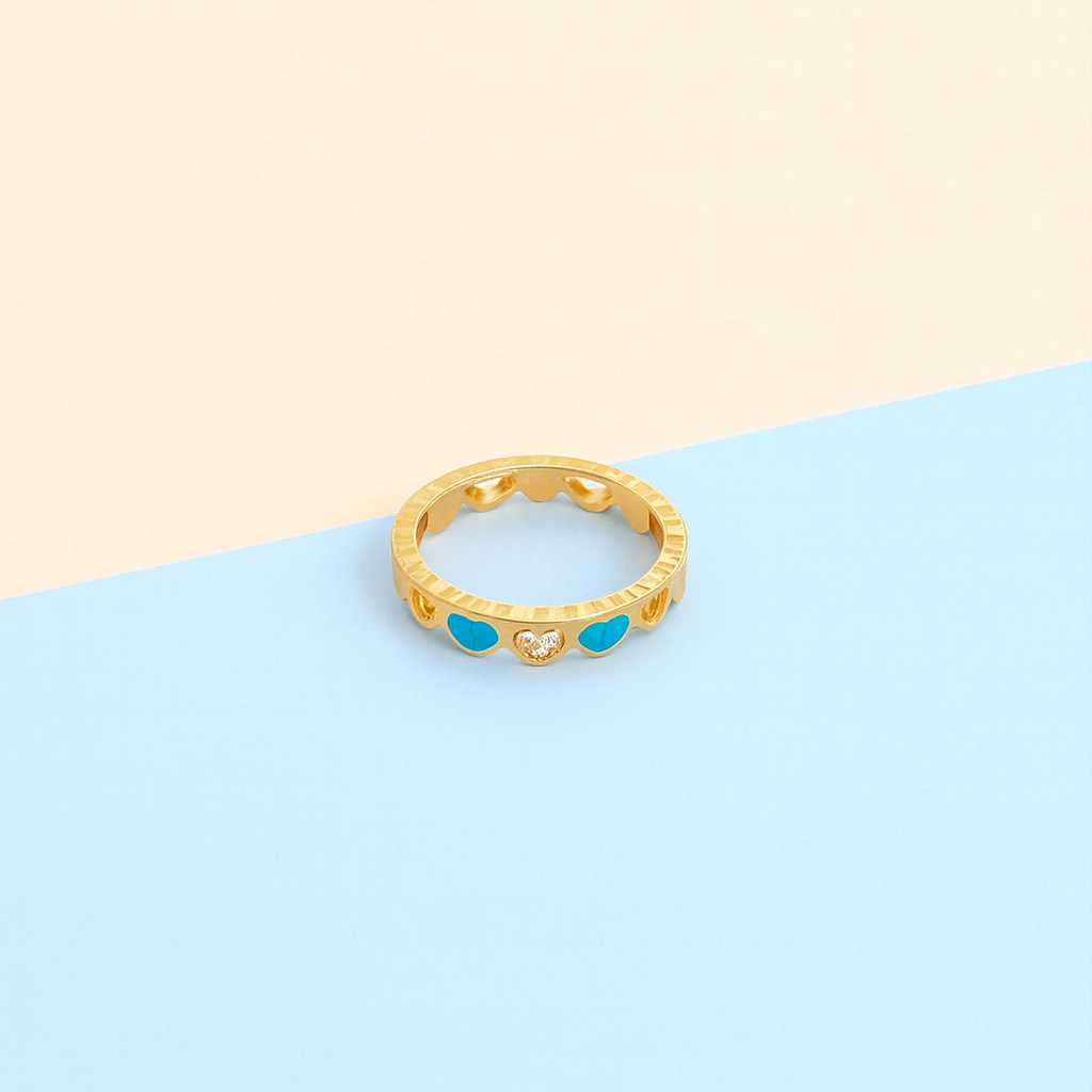 Gold ring with blue gemstones on a two-tone background