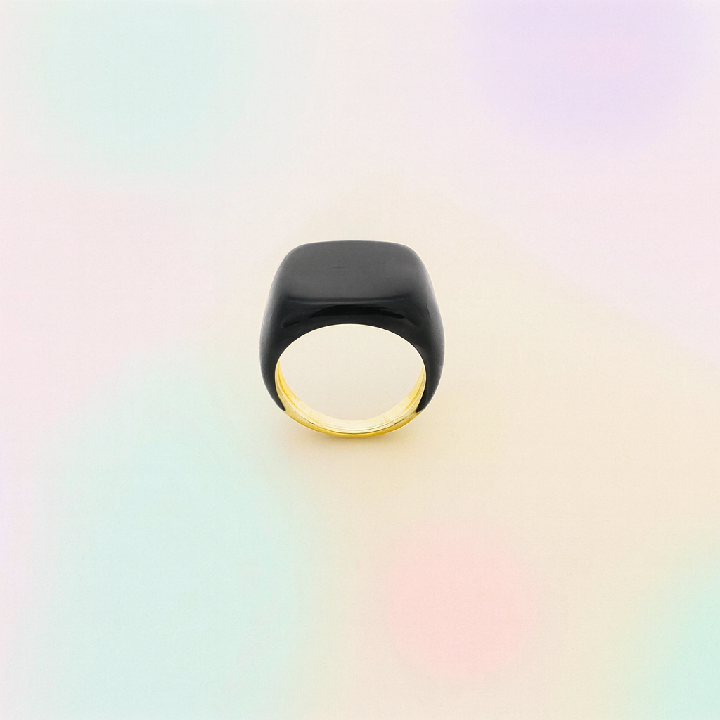 Black ring with gold band on a gradient background