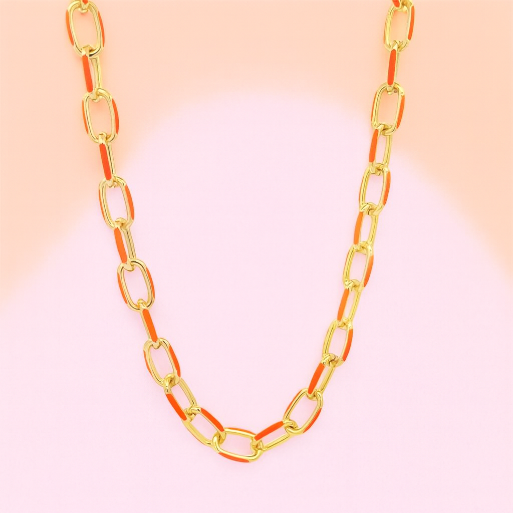 Gold and orange chain necklace on a gradient background