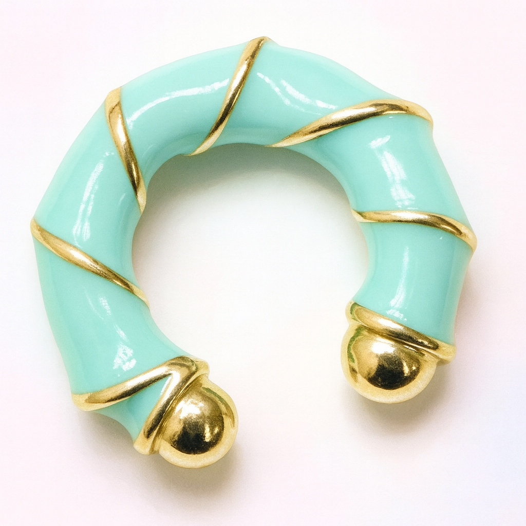 Turquoise ring with gold accents on a white background