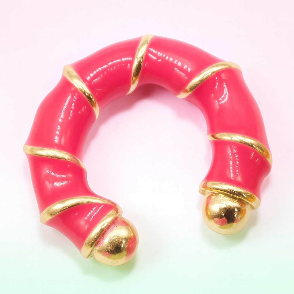 Pink ring with gold accents on a white background