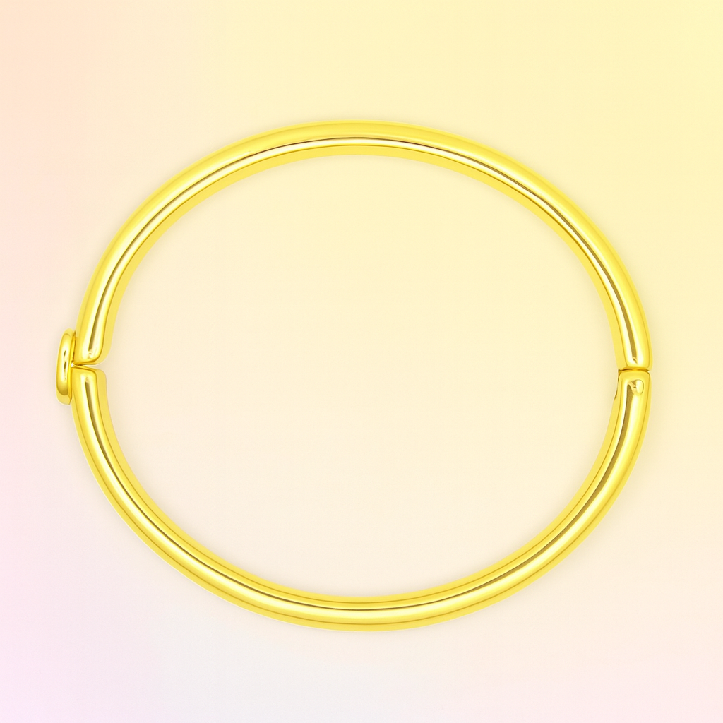 Gold bangle on a light pink background