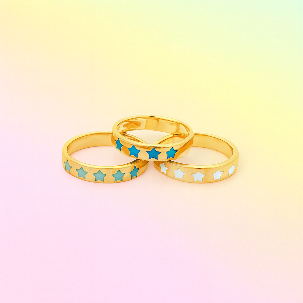 Three gold rings with star designs on a gradient background