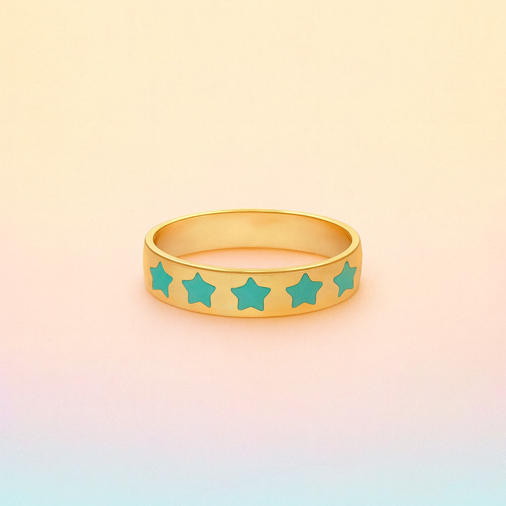 Gold ring with turquoise stars on a gradient background