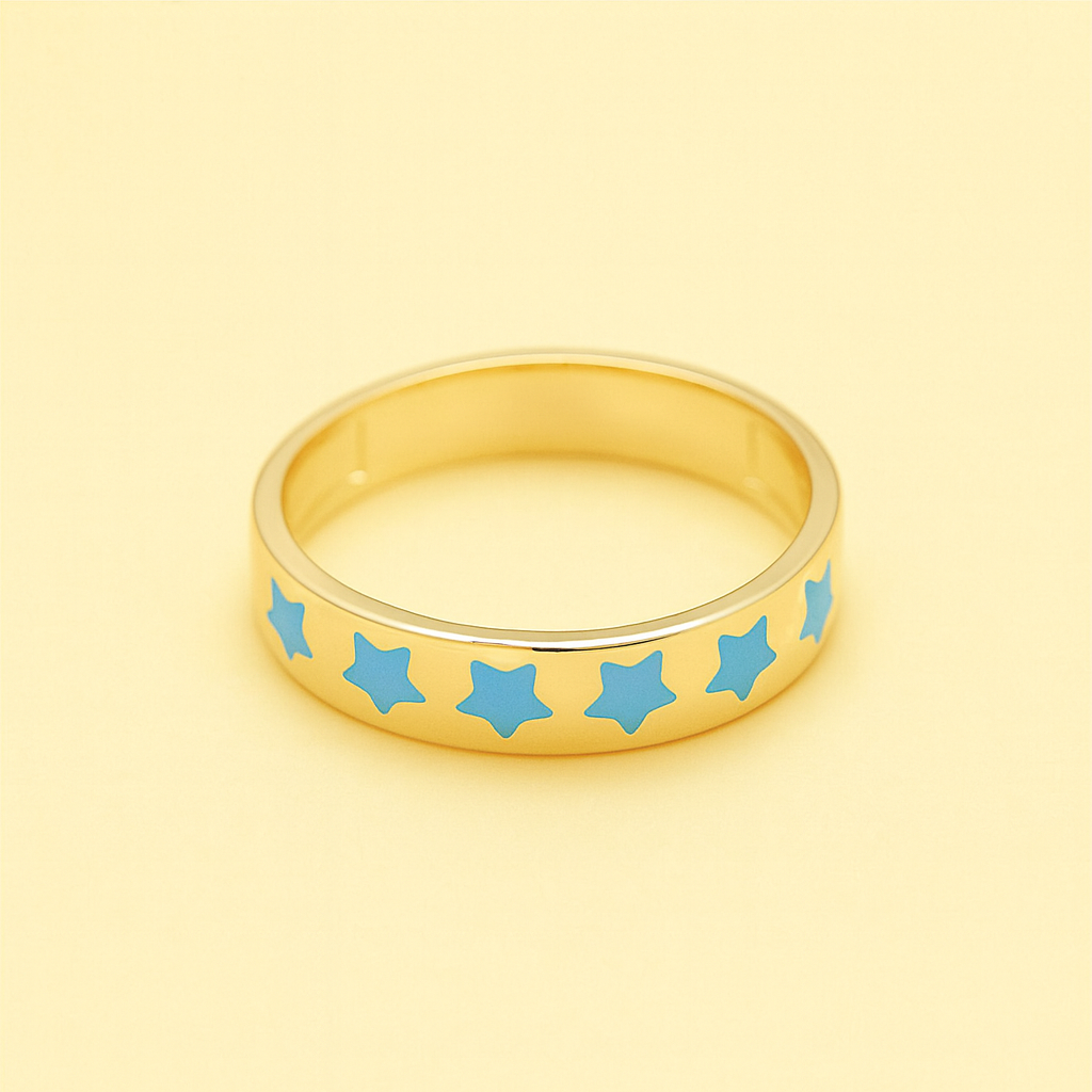 Gold ring with blue star patterns on a yellow background