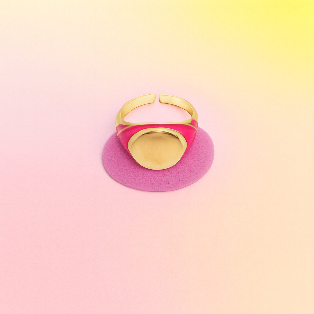 Gold ring with pink band on a gradient pink and yellow background