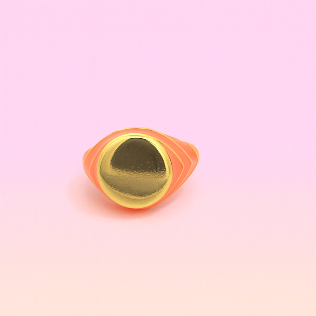 Gold ring with orange rim on a pink gradient background