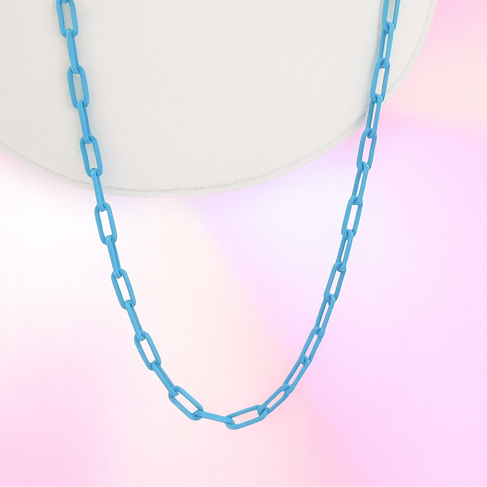 Blue chain necklace on a gradient background