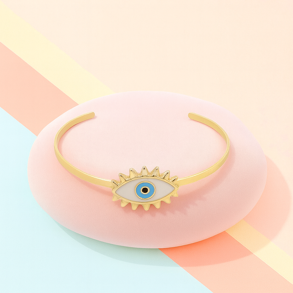 Gold bracelet with eye design on a colorful background