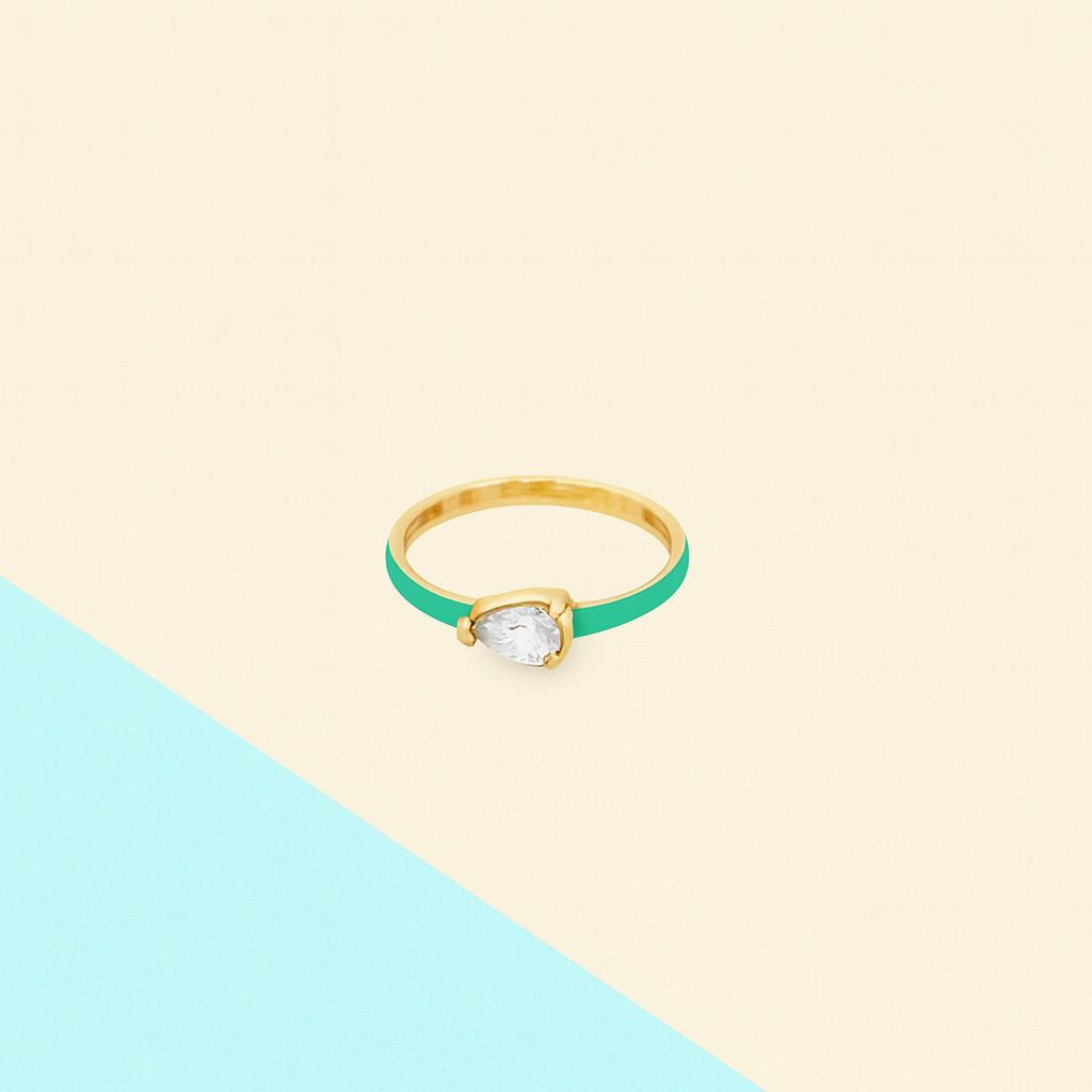 Gold ring with a green band on a two-tone background