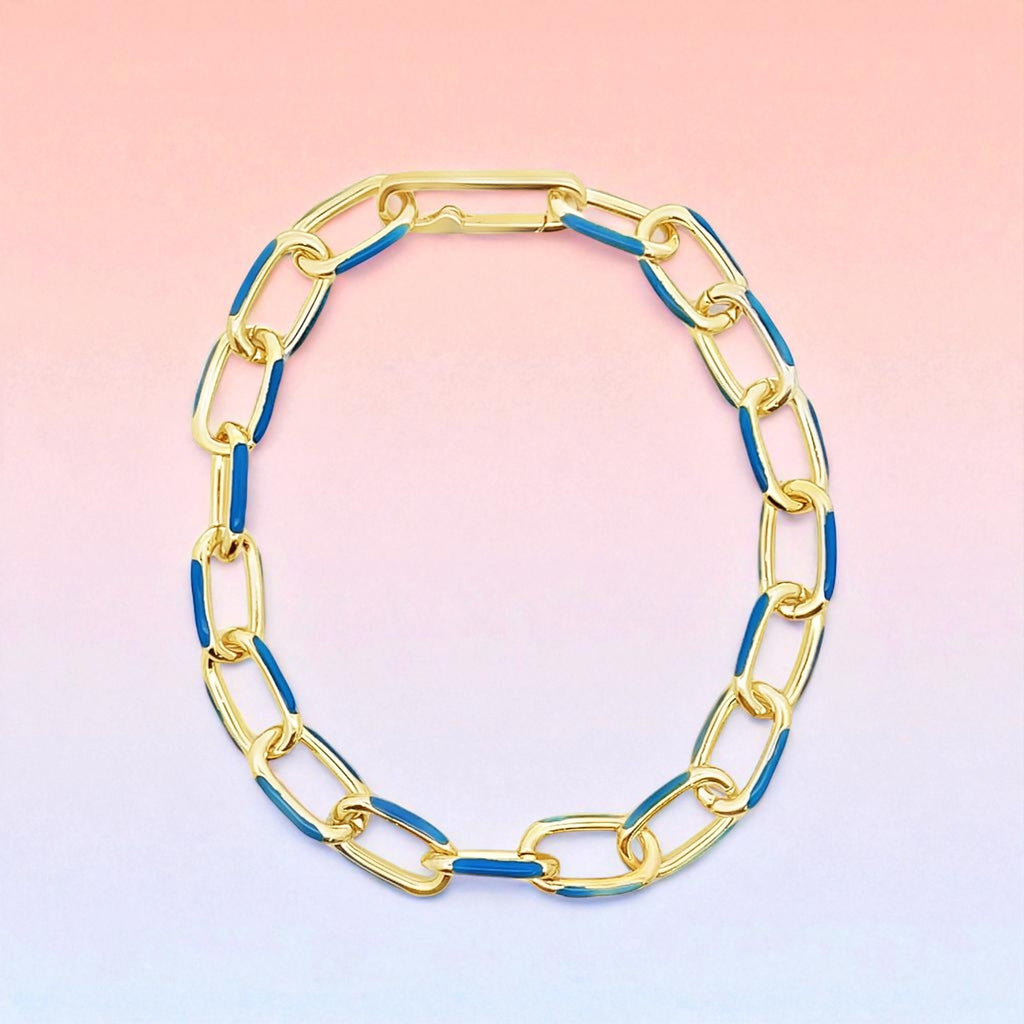 Gold and blue chain necklace on a gradient background